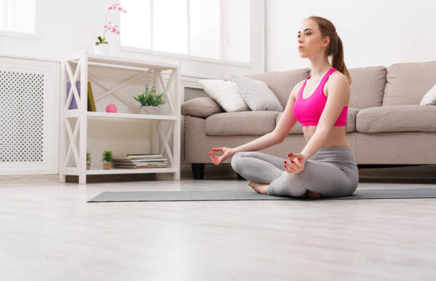 istock Woman training yoga in lotus pose 969549518