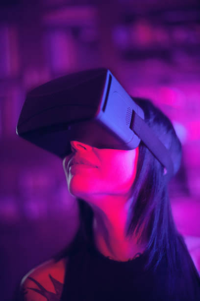 istock Young woman looks fascinated into Virtual Reality Headset 969549890