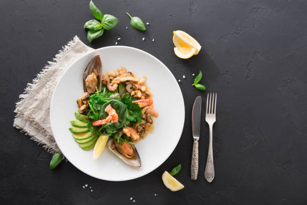 Warm salad with grilled seafood flat lay