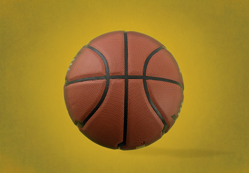 Basketball ball on yellow background