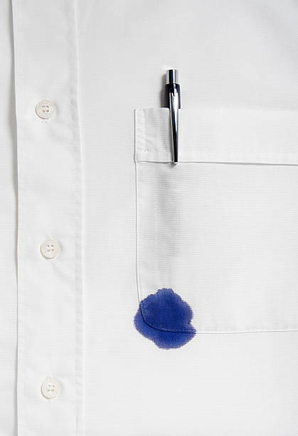 Spot of blue ink from a pen on a white shirt close up of businessman ruined shirt and and leaking pen pen leaking stock pictures, royalty-free photos & images