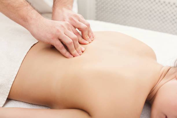 istock Closeup of hands massaging female back 969559526