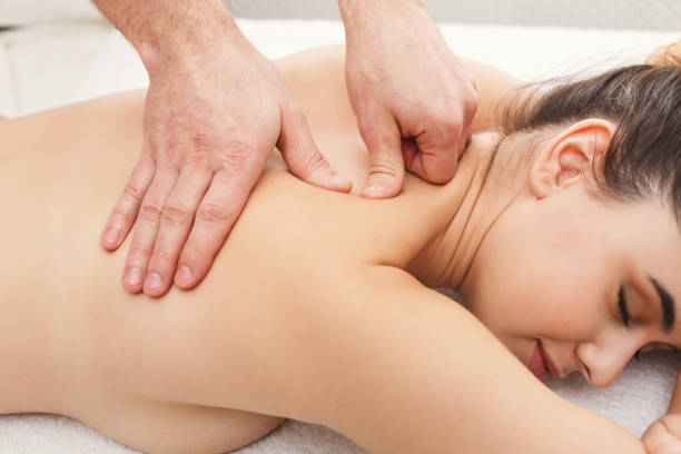 istock Closeup of hands massaging female shoulders 969559574