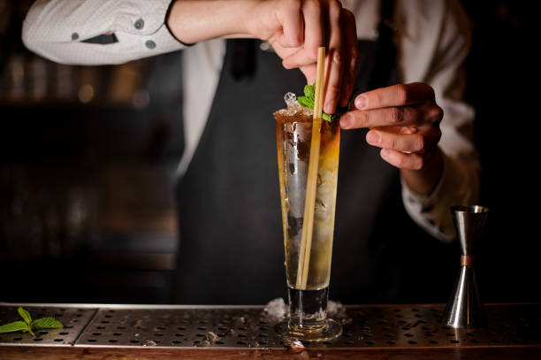 istock Barman adding the mint leaves to the summer cocktail 969564084