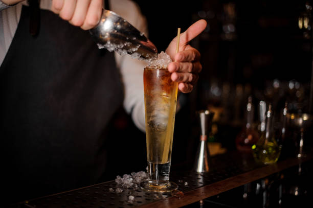 istock Barman adding an ice into the summer cocktail 969564396