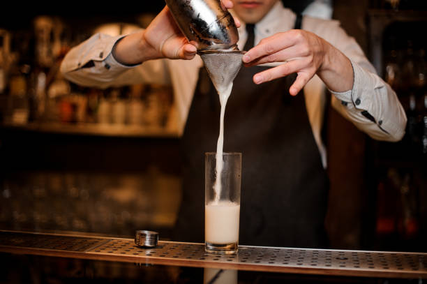 istock Bartender adding an alcoholic drink from the steel shaker 969564544