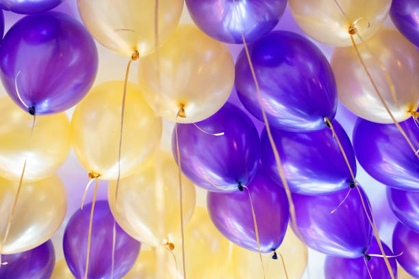 istock gold and purple party balloons 969570874