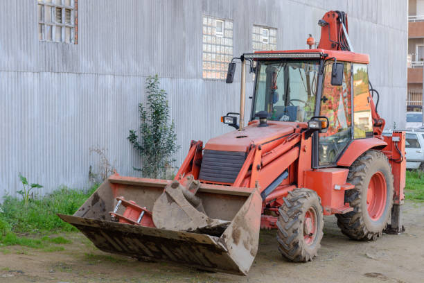 istock red tractor parked near a gray wall 969570920