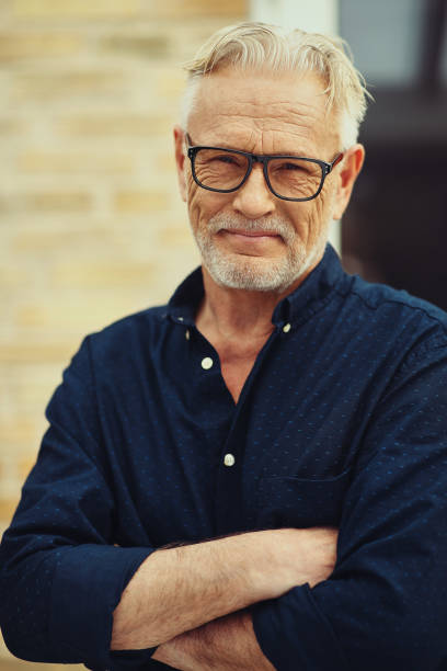 istock Content senior man standing in front of his home 969571158