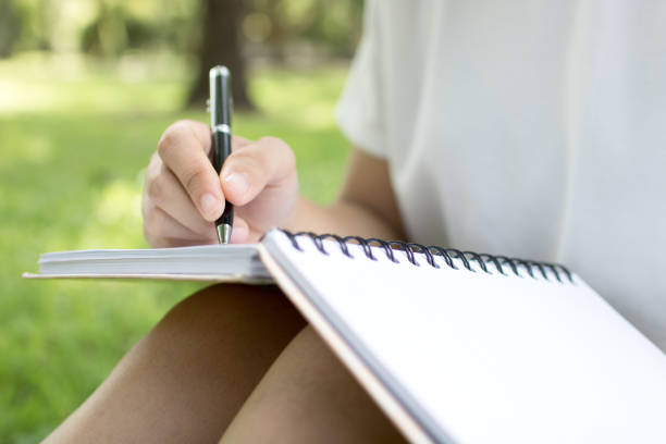 istock women writing on green grass 969571972