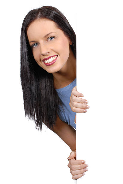 istock Friendly girl peeking round a white board 96957364