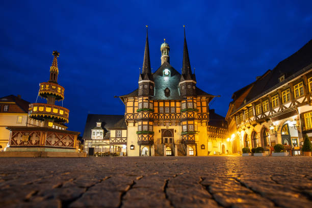 Wernigerode, Germany: View of the historic city hall and the historic benevolent-fountain at night.