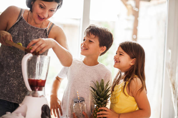 istock woman and her child cutting fruit in the kitchen 969578156