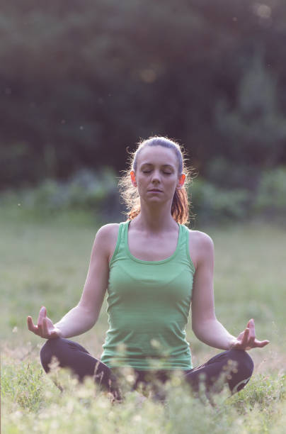 istock Girl meditating in park 969578184