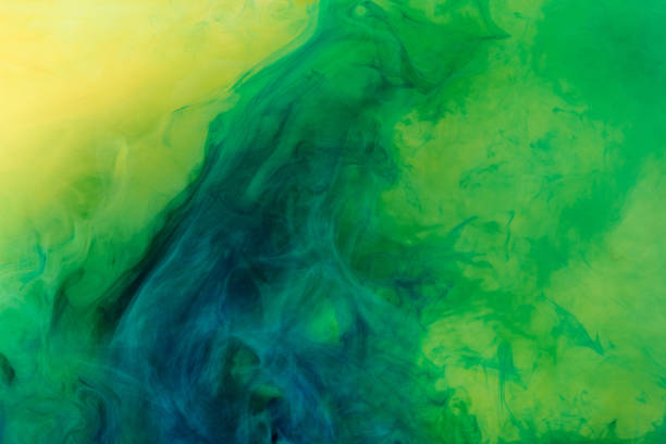 istock artistic background with green paint flowing in water 969578636