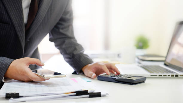 istock Businessman using mobile phone and calculator financial concept analysis data. 969578782