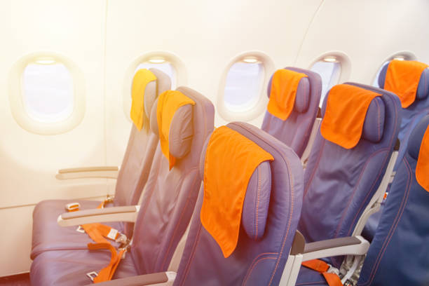 istock Blue airplane empty seats with windows. Aircraft interior. 969579512