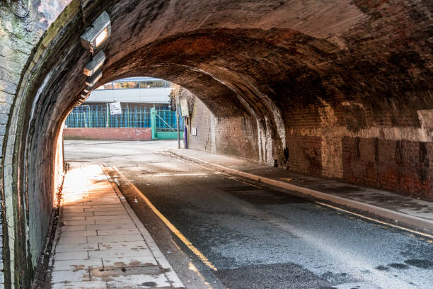 istock Old Victorian arched brick tunnel 969579756