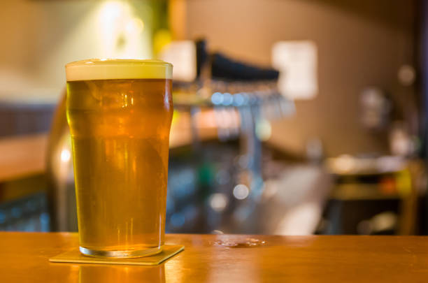 Glass pint of beer on top of bar counter, brewpub, craftbeer.