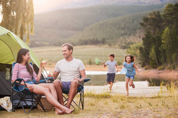 家族一緒に湖でキャンプの休暇を楽しんで - camping family nature tent ストックフォトと画像