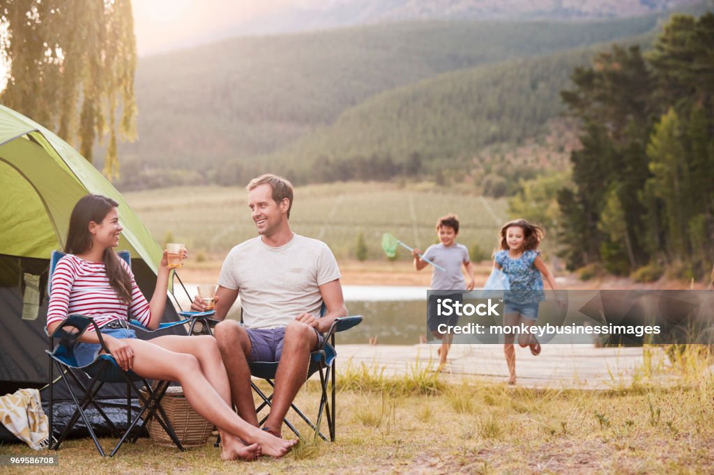 Family Enjoying Camping Vacation By Lake Together Camping Stock Photo