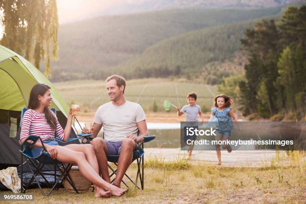 Family Enjoying Camping Vacation By Lake Together Stock Photo - Download Image Now - Camping, Family, Vacations