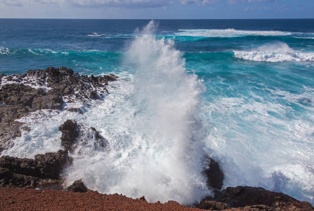 istock Majestic ocean waves crash against the black rocks 969587278