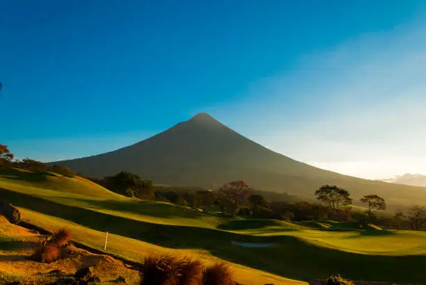 Photo of Agua volcano sunrise in Guatemala, golf club La Reunion. 3,760 m. Central America. Nature reserve attractive landscape tourism.