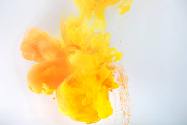 istock artistic background with flowing yellow and orange paint, isolated on grey 969590690