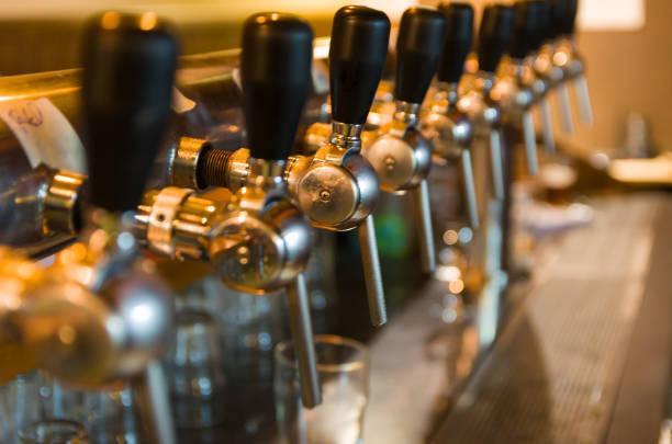 istock Beer taps on bar counter, brewpub. 969592094