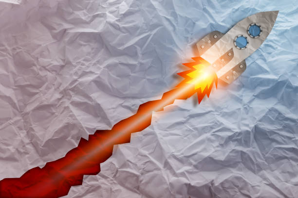 istock rocket papercut shape with Crumpled fold white paper sheet background 969595104