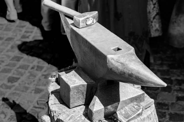 istock Hammer and anvil from a medieval forge in black and white 969595564