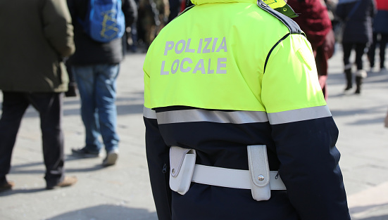 Policeman with uniform and the text POLIZIA LOCALE that meas Local Police in Italian language