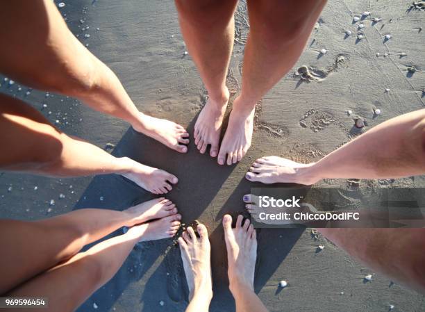 Barefoot Feet Of A Family Of Five With Legs On The Sandy Beach F Stock Photo - Download Image Now