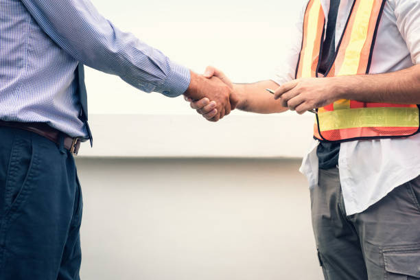 istock Businessman and engineer handshake after deal successfully at construction site 969596900