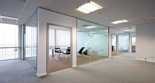 Contemporary office with an open-concept layout Open plan office lit by natural and artificial light screen partition stock pictures, royalty-free photos & images