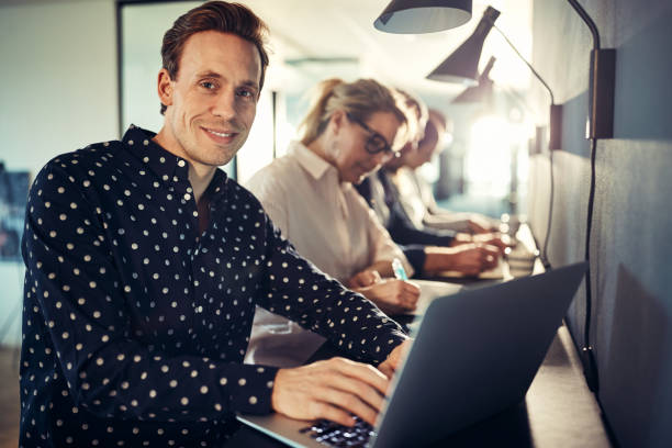 istock Smiling young designer working with colleagues in an office 969597618