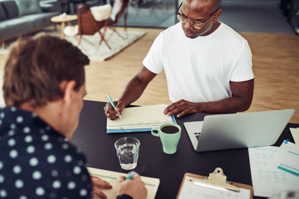 istock Two businessman working together at a desk in an office 969597722