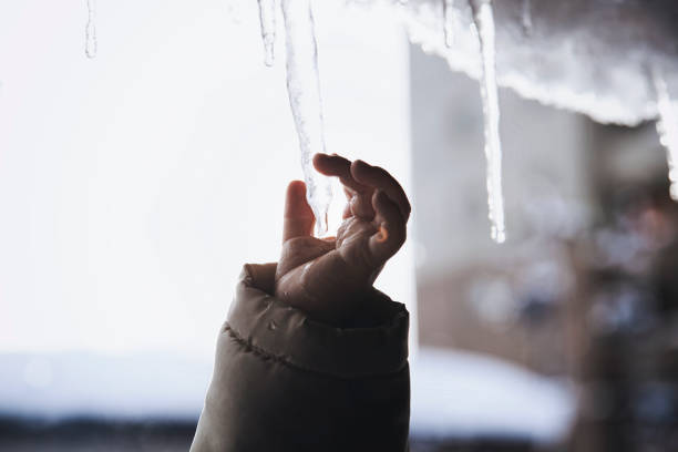 A selection of hi resolution images of icicles at various stages and angles against a blue sky.