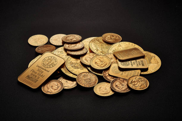 Yellow gold bars and coins isolated on black background Yellow gold bars and coins isolated on black background. top gold ira stock pictures, royalty-free photos & images