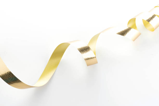istock Golden ribbon roll isolated on white background 969605032