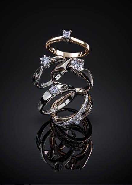 istock engagement diamond wedding ring group isolated on black background 969612688