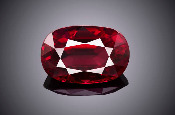 istock Luxury red transparent sparkling gemstone  shape oval cut ruby isolated on grey background 969613056