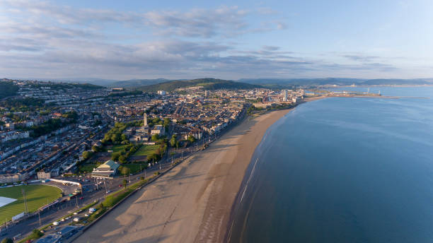 Swansea South Wales UK Editorial SWANSEA, UK - June 2, 2018: An aerial view of Swansea Bay, South Wales, UK, showing Victoria Park to the city centre bay of water stock pictures, royalty-free photos & images