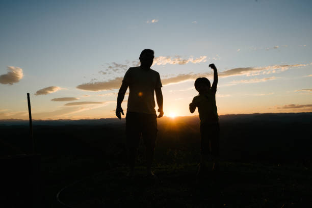 istock Father and son having fun at sunset 969613864