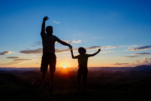 istock Father and son having fun at sunset 969613878