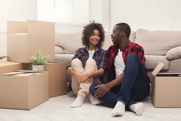 istock Young balck couple unpacking moving boxes 969623728