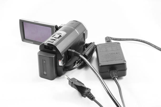 Video camera and battery charger, Old technology isolate on white background.