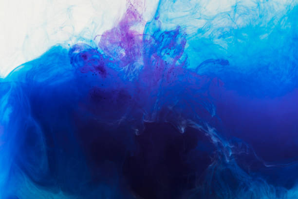 istock abstract background with flowing blue and purple paint in water 969624582