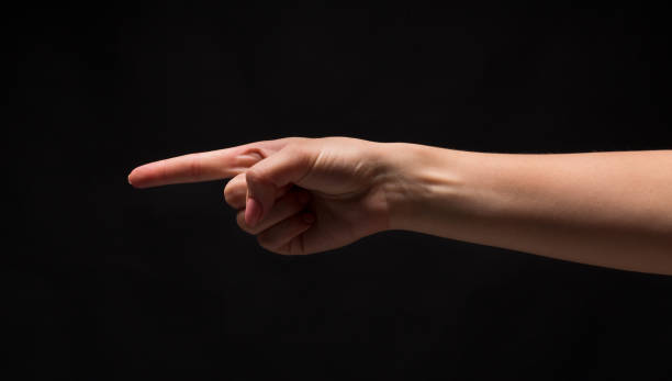istock Hand gestures - woman pointing, isolated at black 969624954